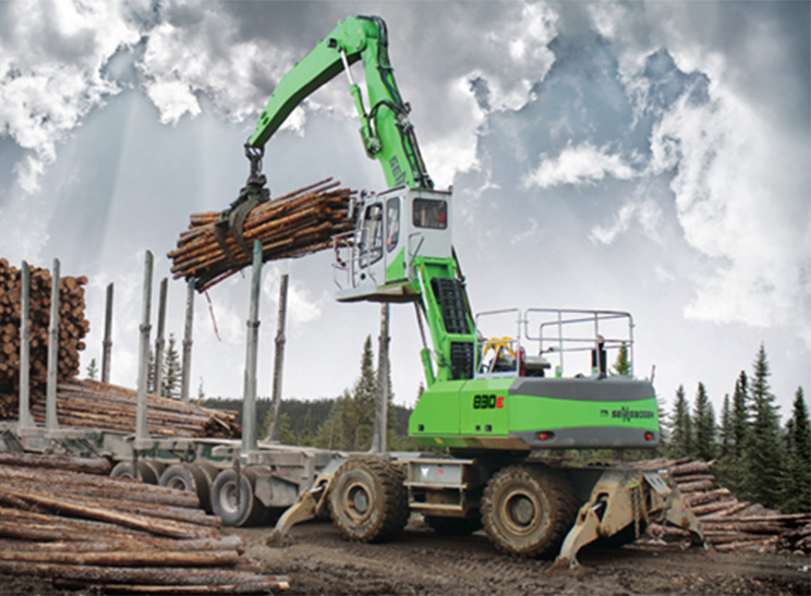 Logging Equipment. Image of logs being loaded on truck.